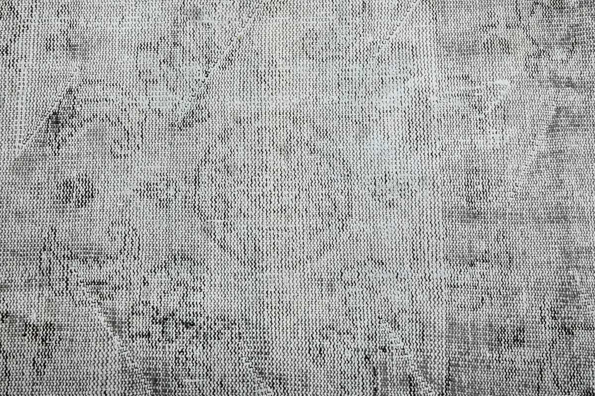 Detailed view of the hand-knotted wool pile showing the subtle floral and medallion motifs