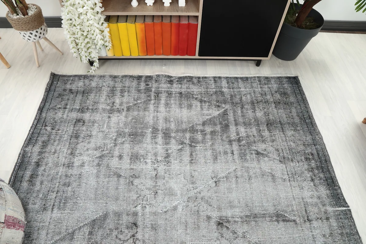 Overhead view showing the full length of the vintage gray rug in a room setup