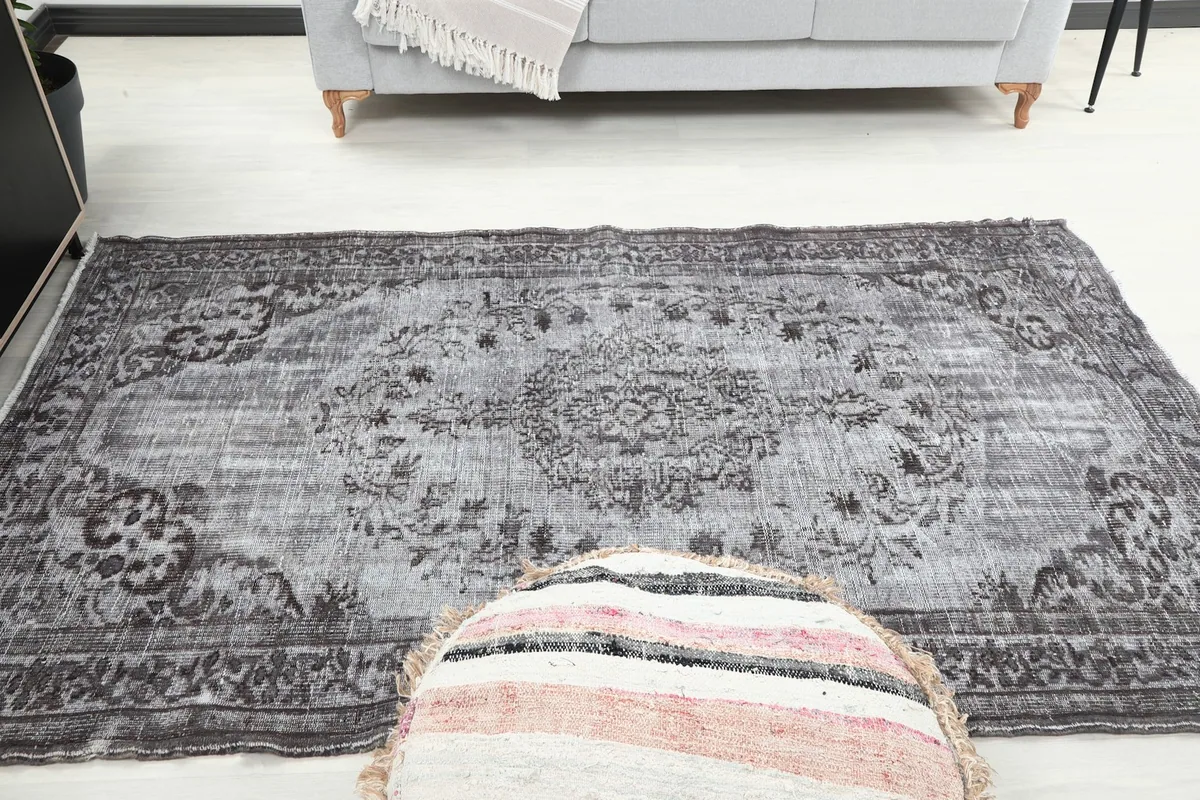 Full length view of the gray Anatolian rug in a staged room, emphasizing its medium size.