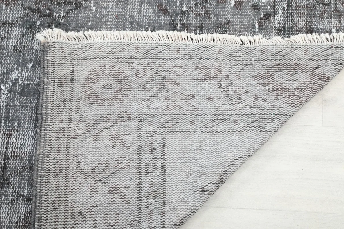 Close-up of the rug's reverse side, revealing the knotting and pattern on the foundation