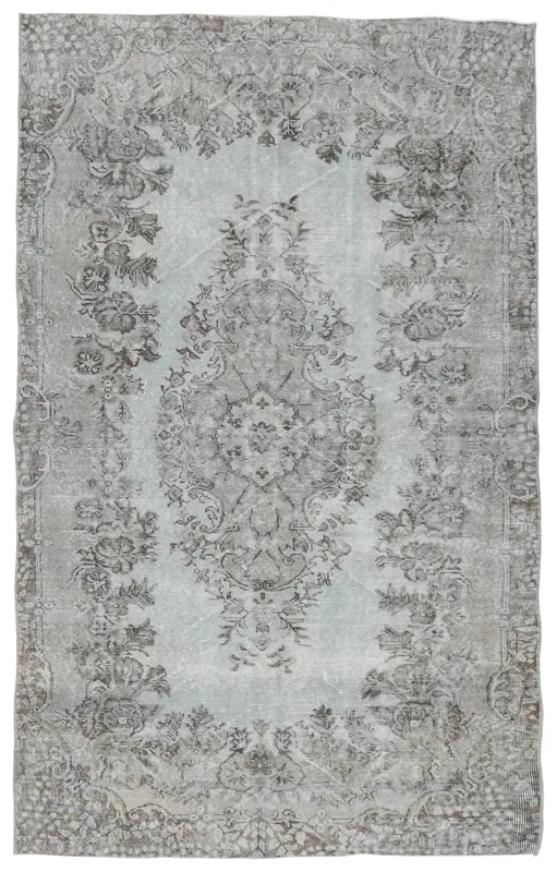 Full top view of the 5'6" x 8'10" vintage Anatolian area rug with a gray and beige medallion and floral pattern