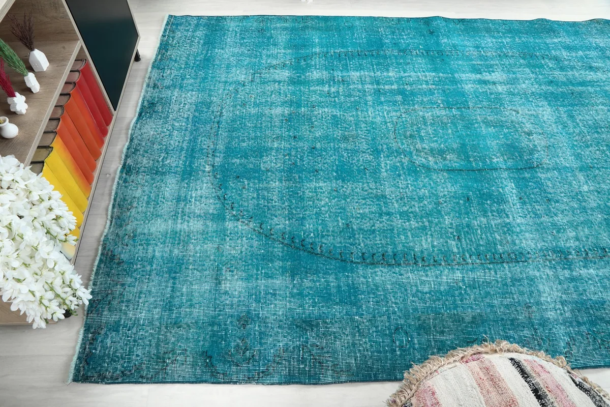 Angled shot of the rug's field, emphasizing the unique color variations and patina