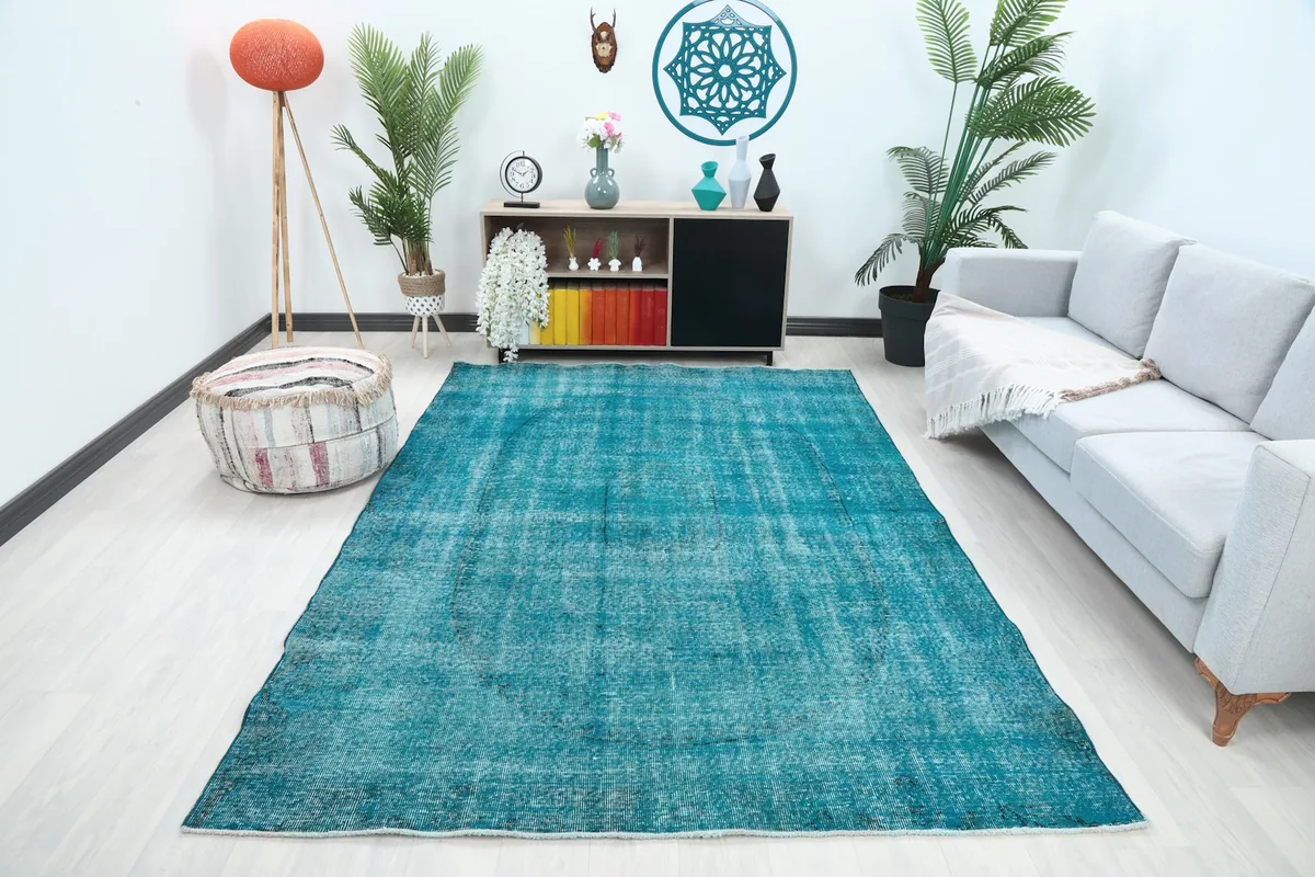 Blue distressed medallion rug in a modern living room setting with a light sofa