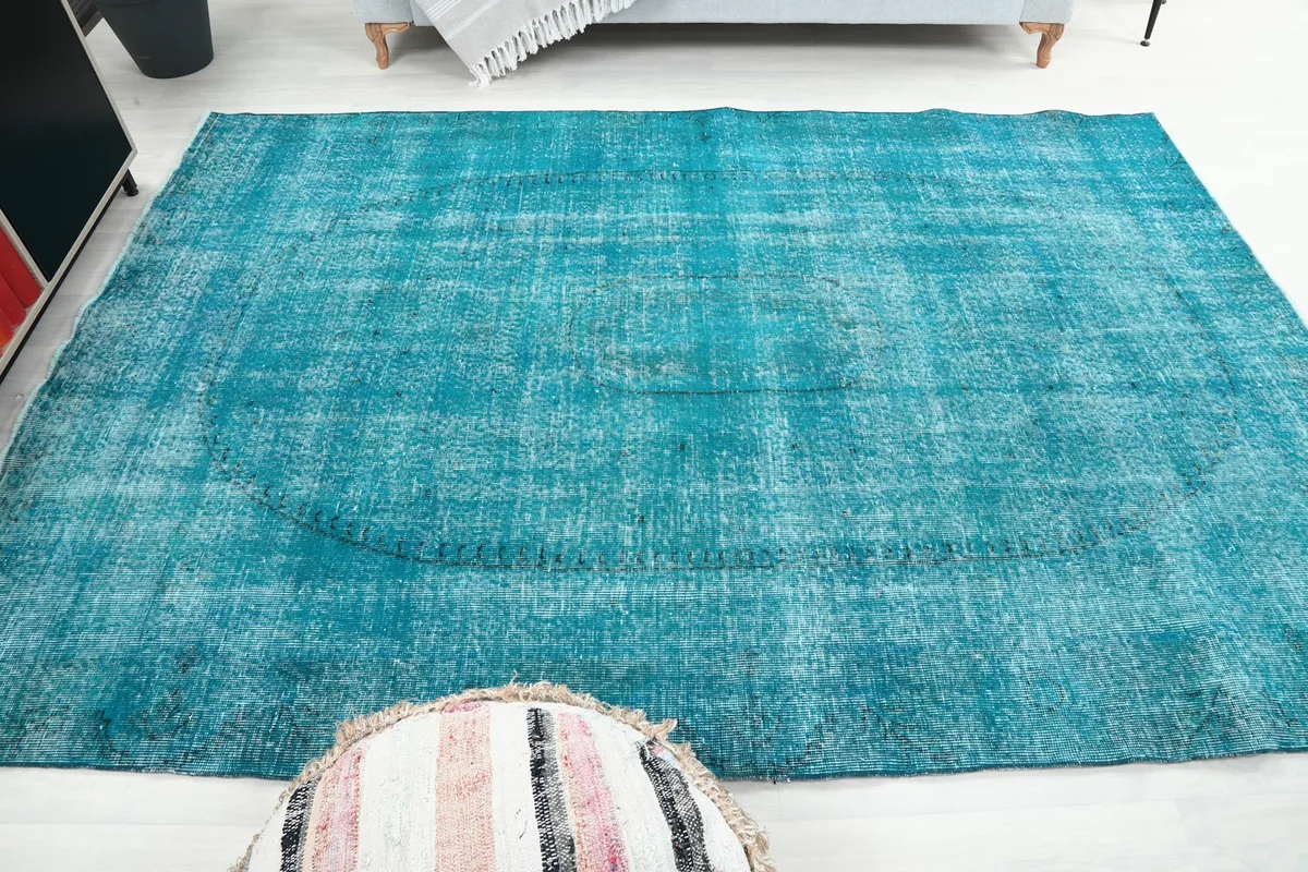 Wide angle showing the blue vintage rug as a focal point in a bright room