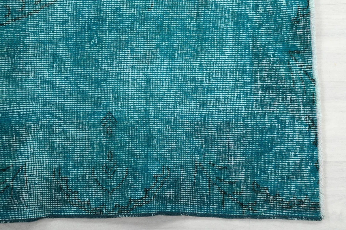 Detailed view of the low pile and variations in the blue color from distressing