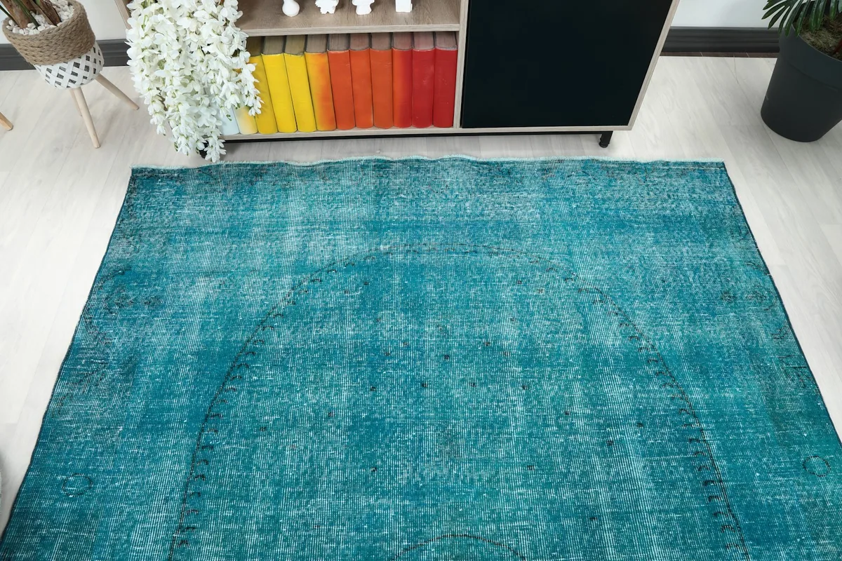 Overhead view of the rug's surface, revealing the overall distressed blue tone