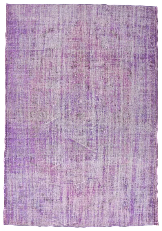 Full overhead view of the purple distressed Anatolian area rug on a white background