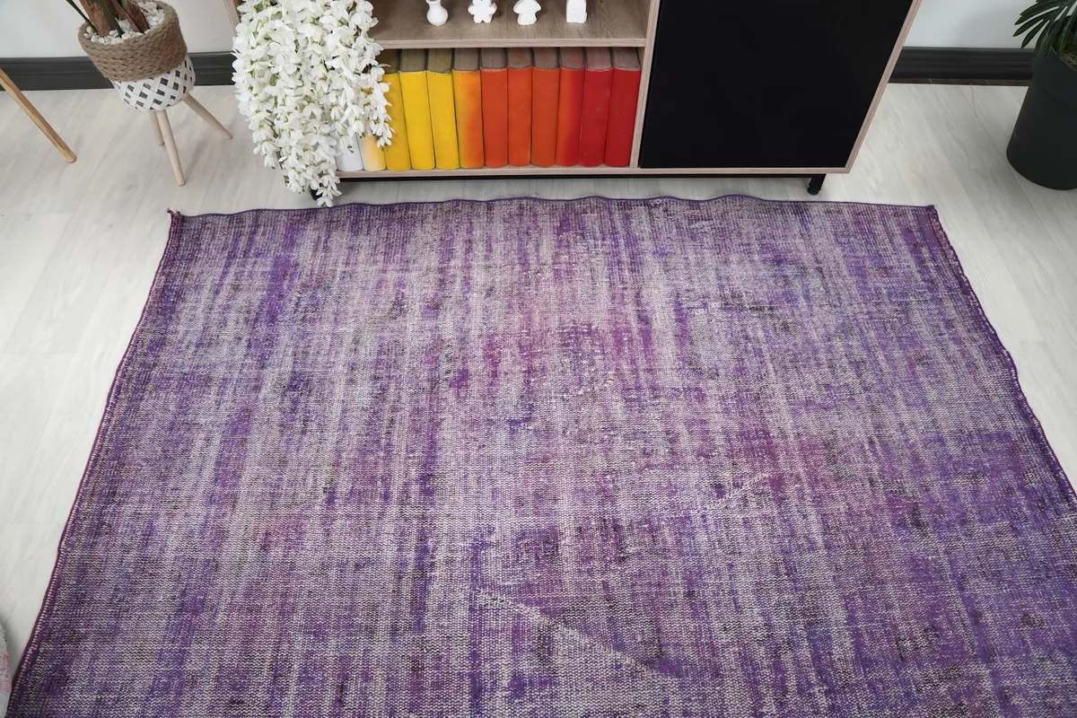 Full overhead shot of the purple vintage rug, emphasizing its rectangular shape and color distribution