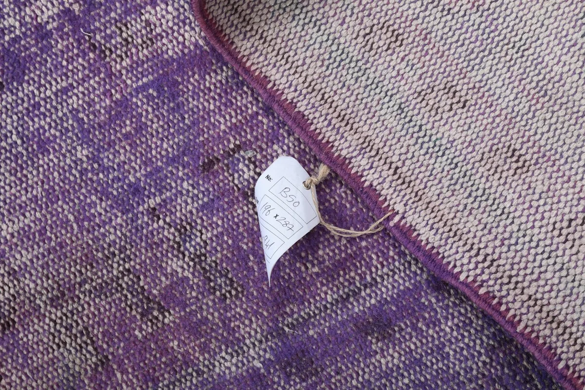 Small tag attached to the back of the rug, indicating its size and origin details