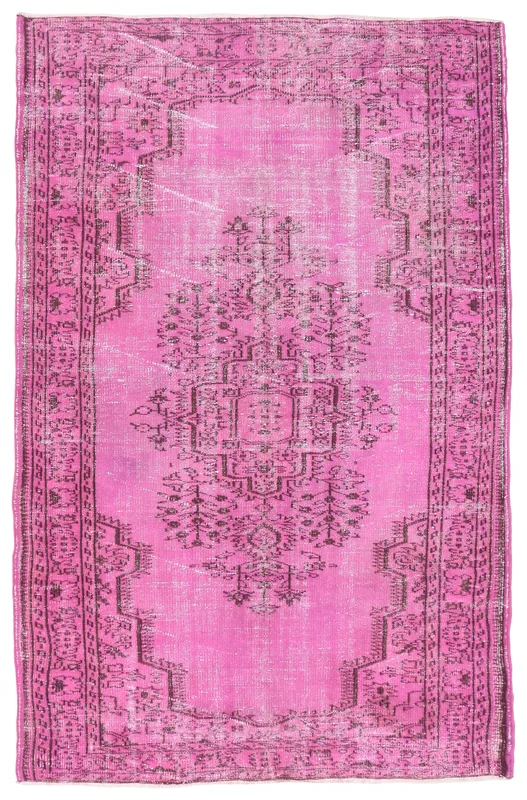 Full overhead view of the pink vintage Anatolian rug with tribal medallion pattern