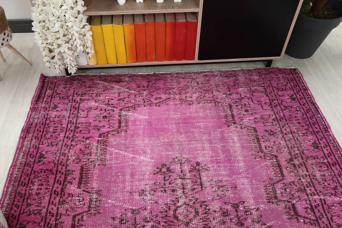 Overhead view of the pink rug in a room, capturing its full design and color