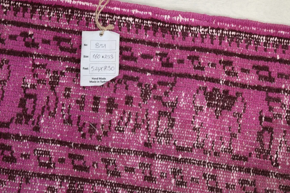 Close-up of the rug's tag, displaying its size and origin information