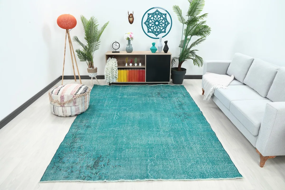 Vintage blue distressed Anatolian rug displayed in a living room setting