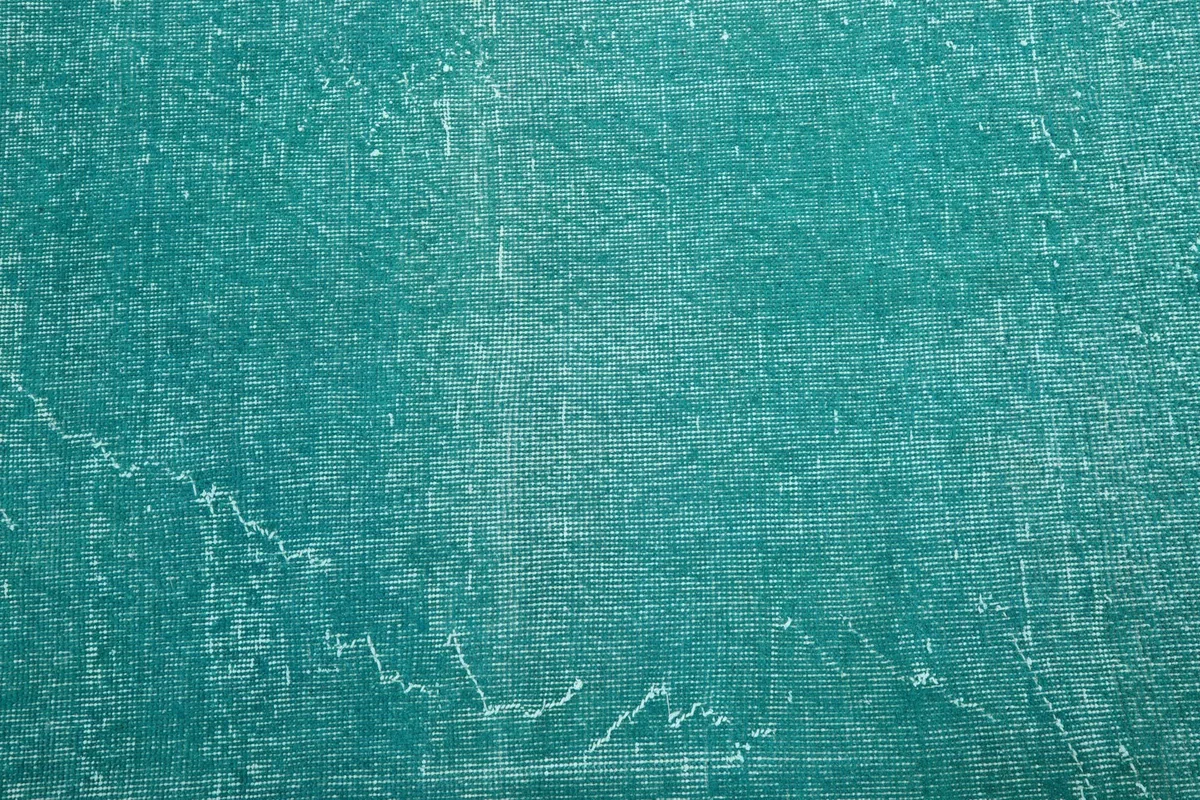 Close-up of the low pile texture and distressed finish of the blue rug
