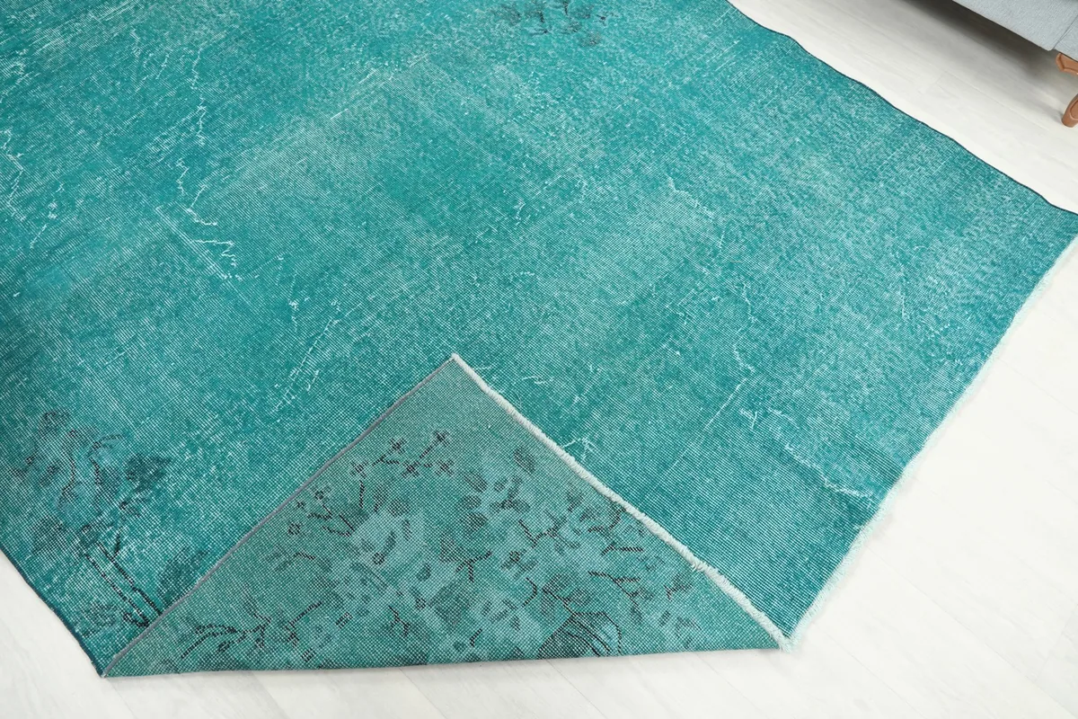 View of the back of the rug, showing the cotton foundation and hand-knotted construction
