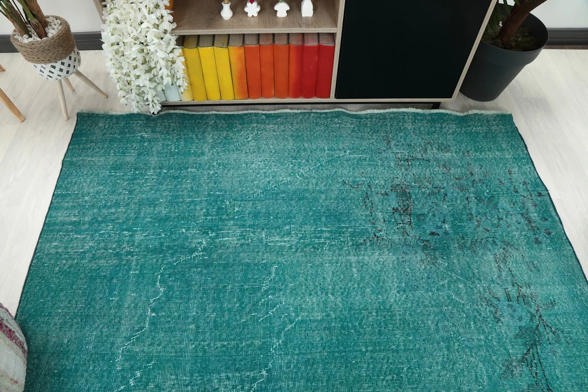 Overhead view showcasing the full spread and color of the blue area rug