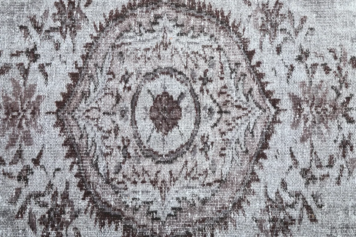 Detailed close-up of the central medallion design on the rug.