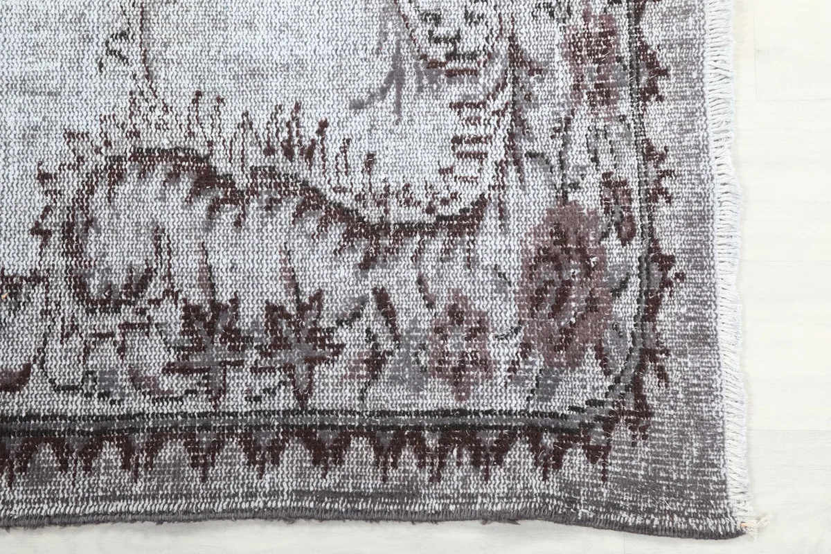 Corner detail of the rug showing the patterned border and field.