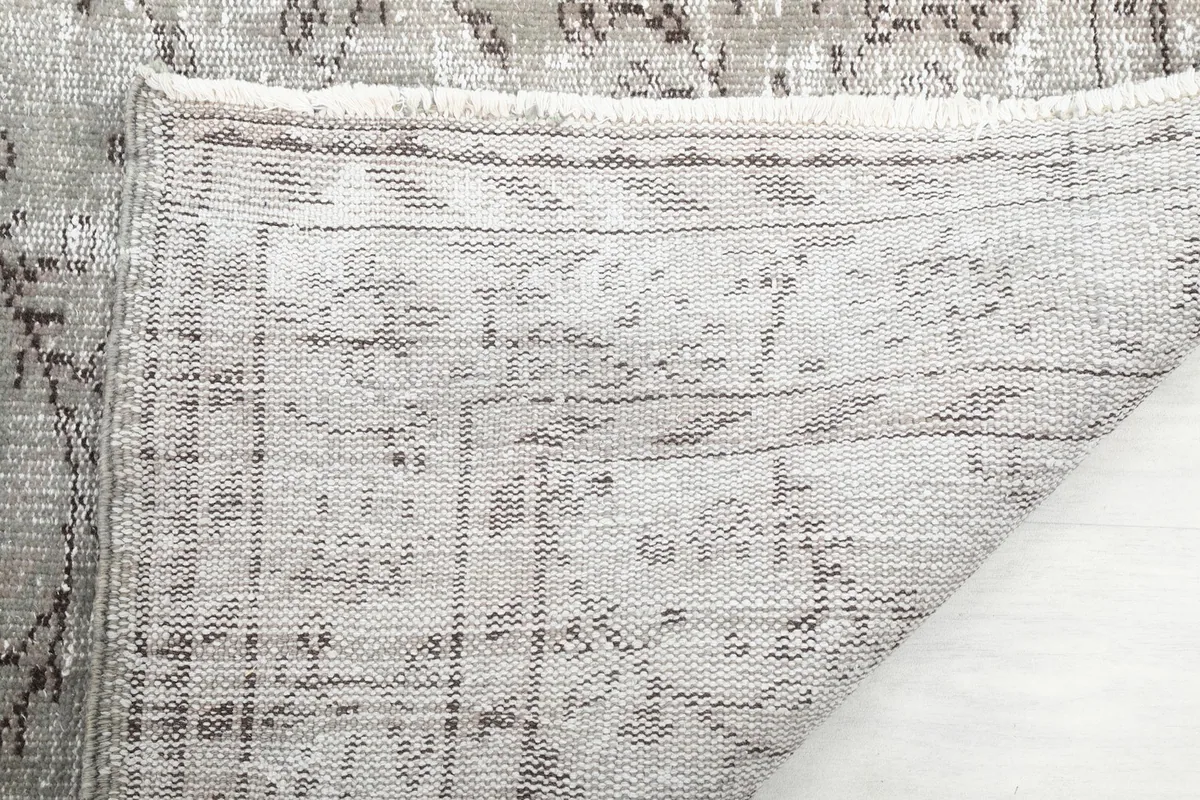 Close-up of the reverse side of the rug, showing the hand-knotted cotton foundation