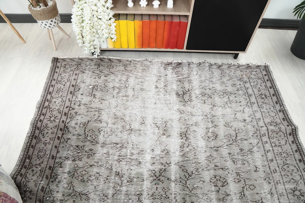 Overhead view of the gray vintage rug, capturing its overall appearance and patina