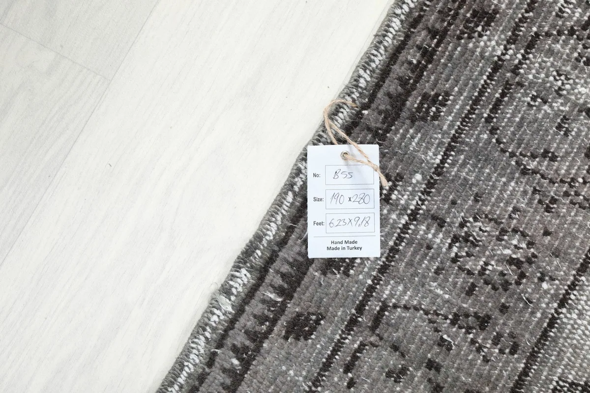 Detail of the product tag attached to the rug, displaying size and origin information