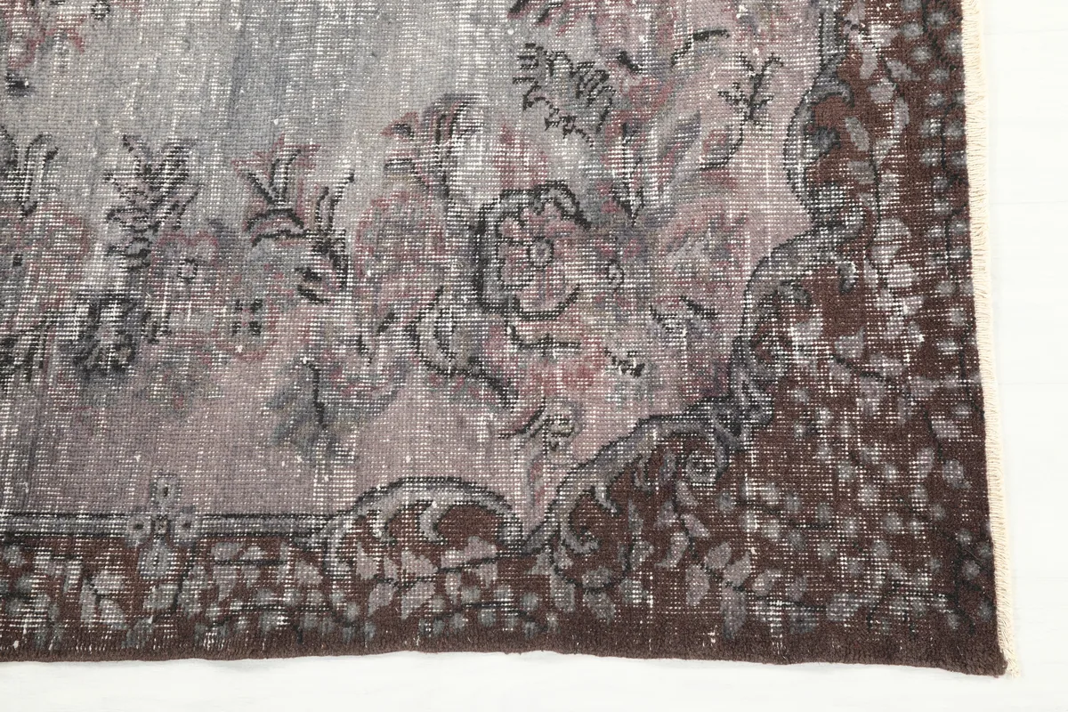 Close-up of the faded floral design and border on the rug