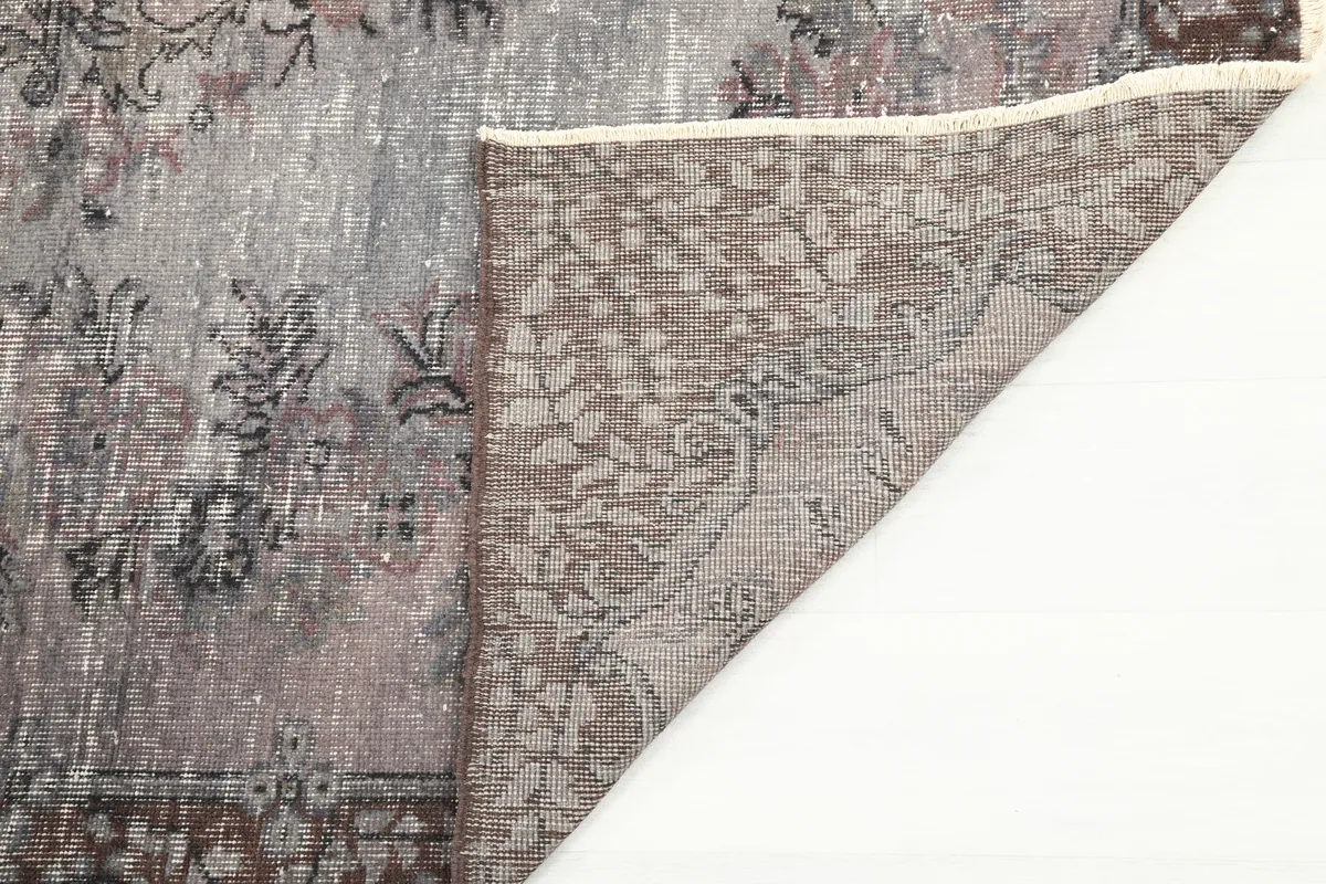 View of the back of the Faded Charcoal Floral Anatolian Rug, showing the hand-knotted foundation