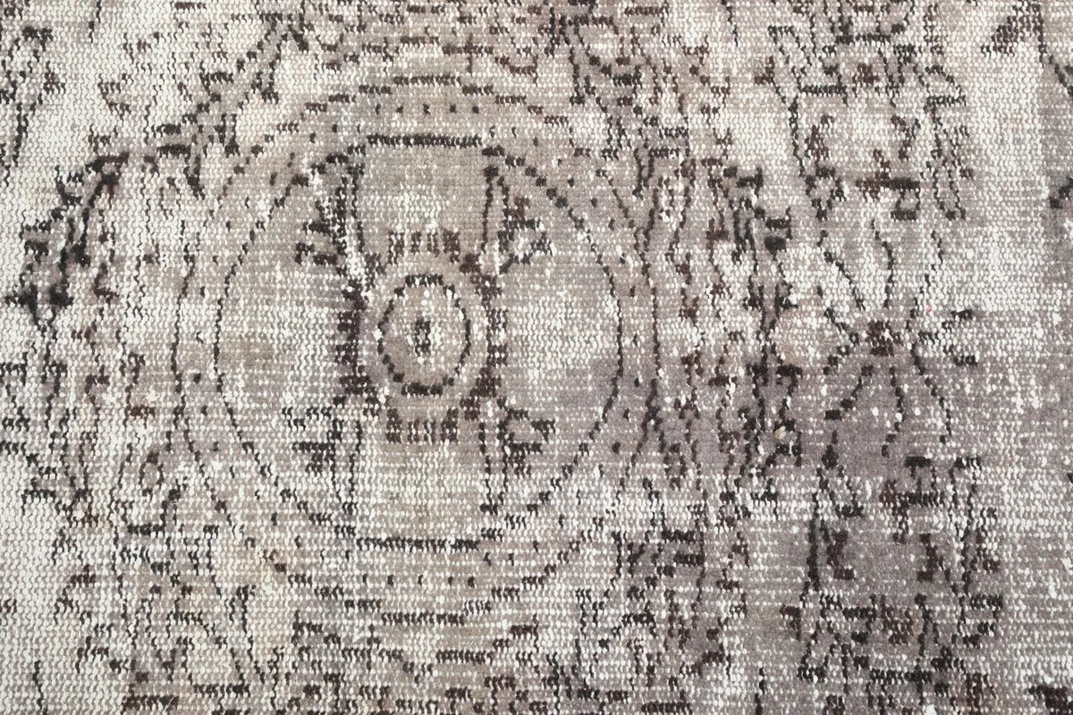 Close-up of the central medallion and field pattern, showing texture