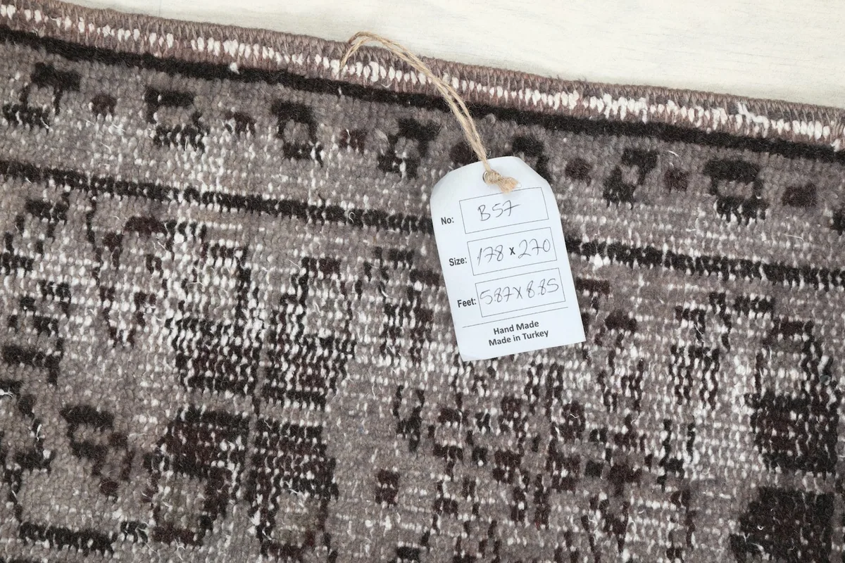 Close-up of the rug's edge with a size tag showing measurements
