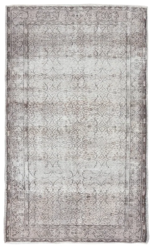 Top view of the 5'3" x 8'10" vintage Anatolian rug with a gray and charcoal floral pattern