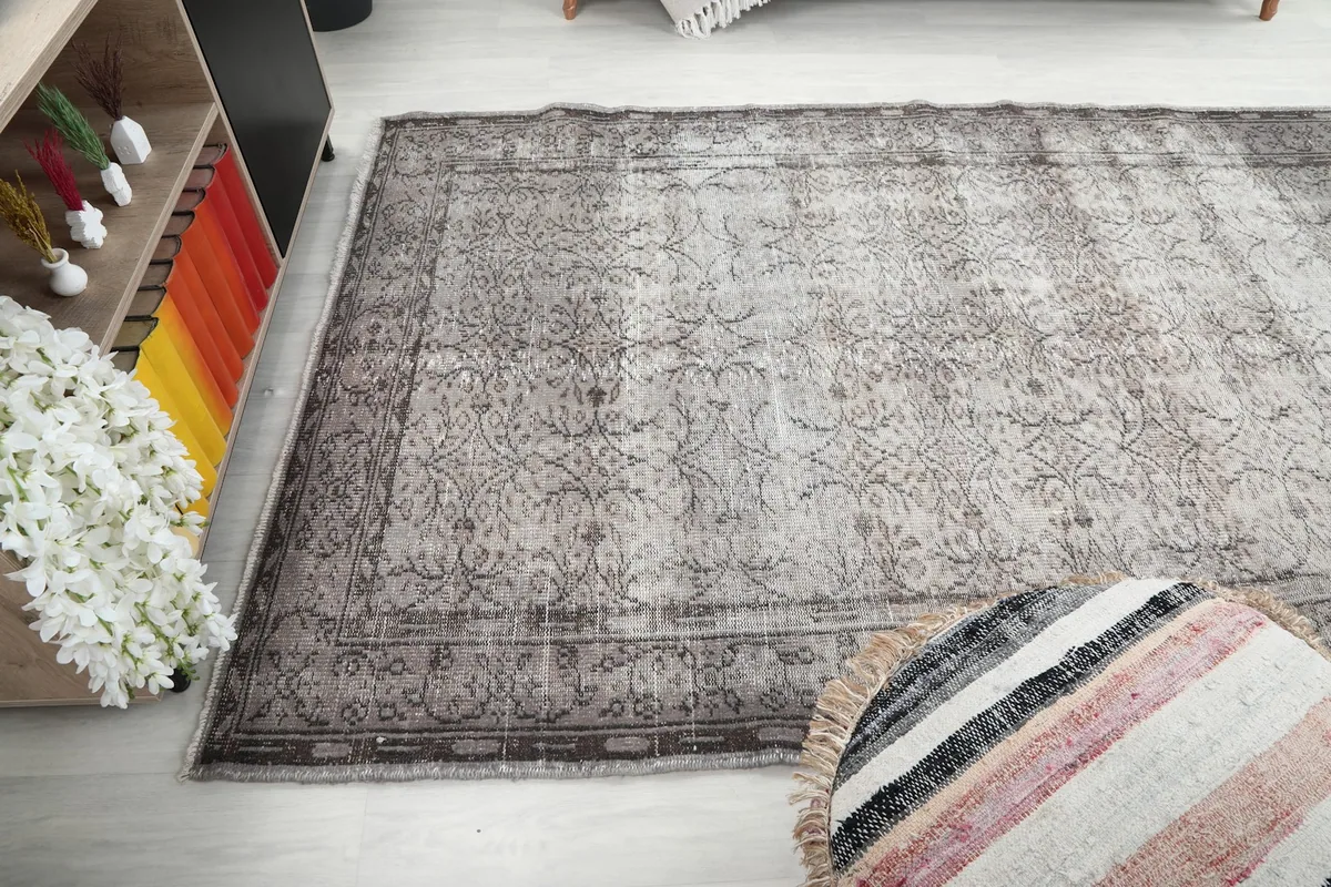 Perspective view of the rug on the floor of a living room, highlighting its length