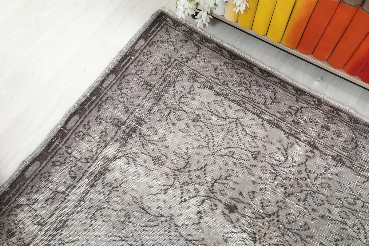 View of the gray and charcoal border design and the main field pattern from an overhead angle