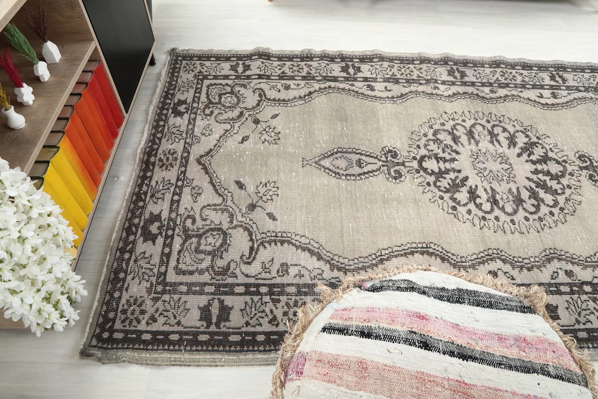 Angled view of the rug's lower section, showing the patterns and border details