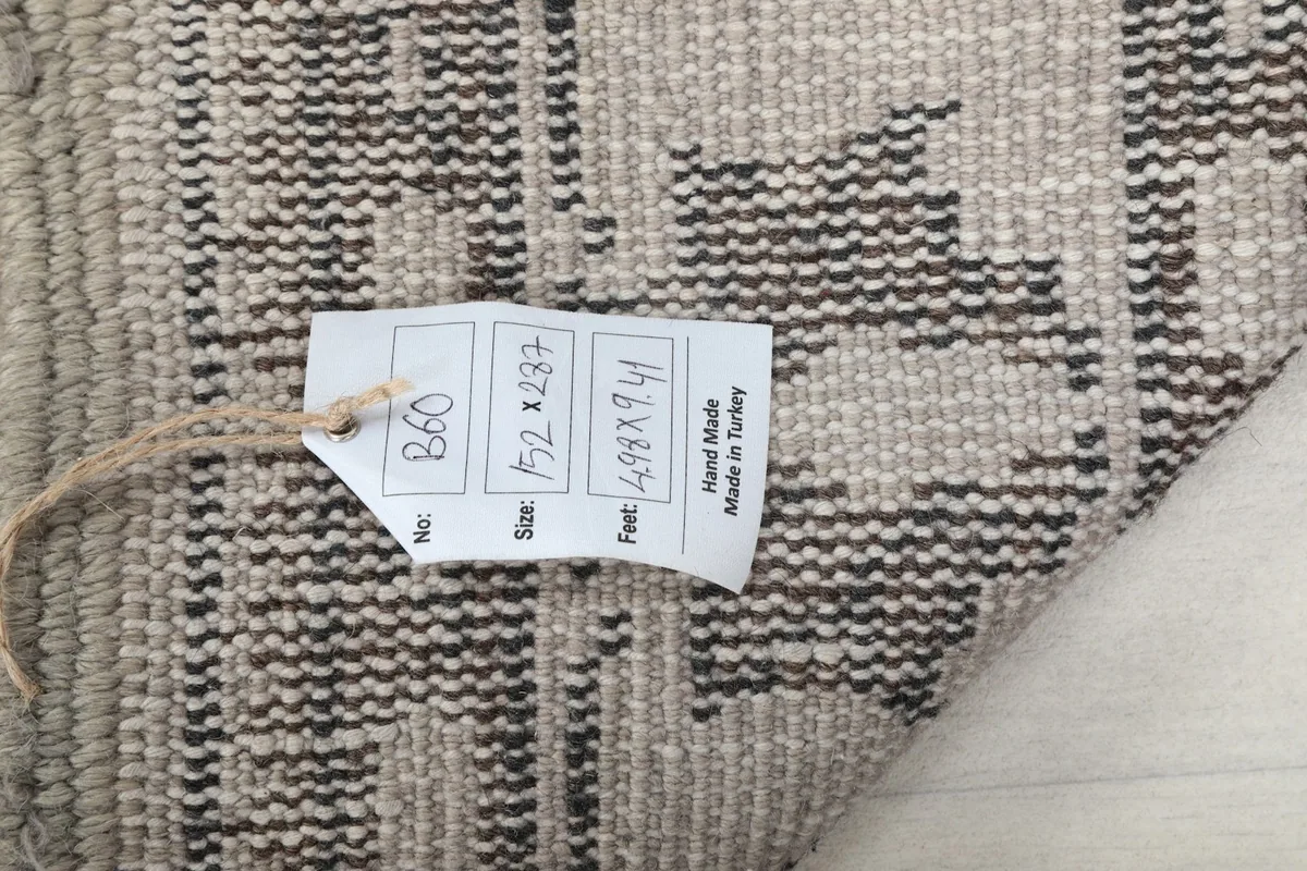 Tag on the back of the rug displaying size and origin information