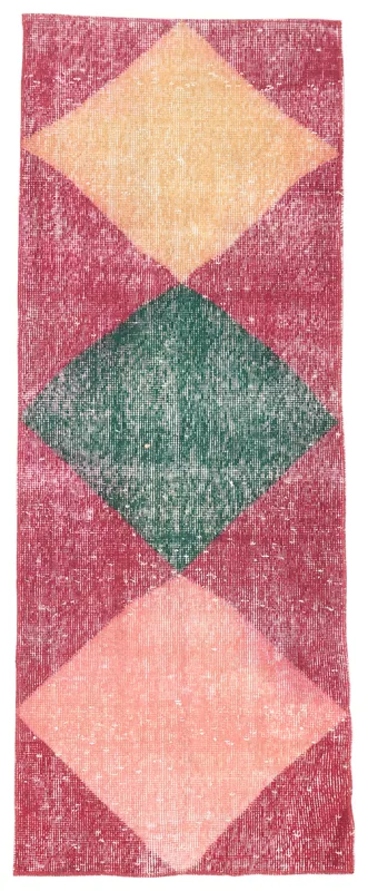 Full overhead view of the red, green, yellow, and rose geometric diamond vintage runner rug.