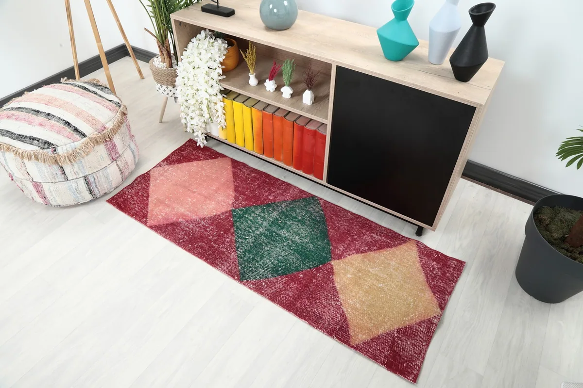 Angled overhead view of the vintage runner rug in a room, showing its placement.