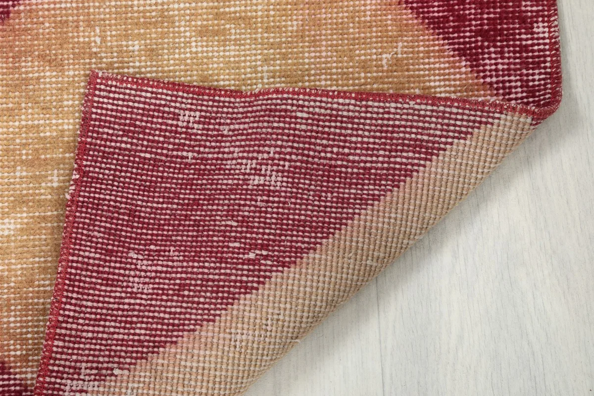 View of the underside of the hand-knotted vintage rug, showing the cotton foundation.