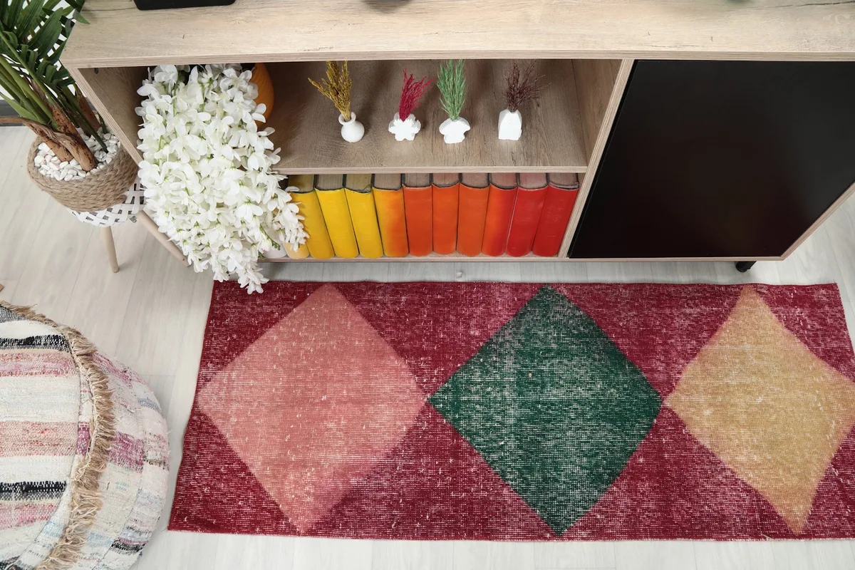 Close overhead view of the runner rug, focusing on the geometric diamond pattern and colors.