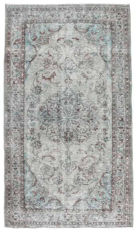 Full overhead view of the gray blue Anatolian vintage area rug on a white background