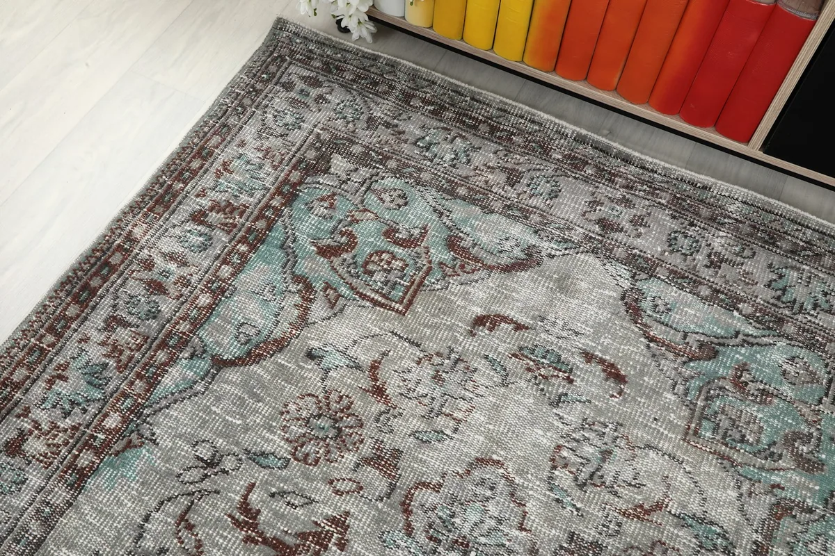 Detailed view of the rug's border pattern and a section of the field design