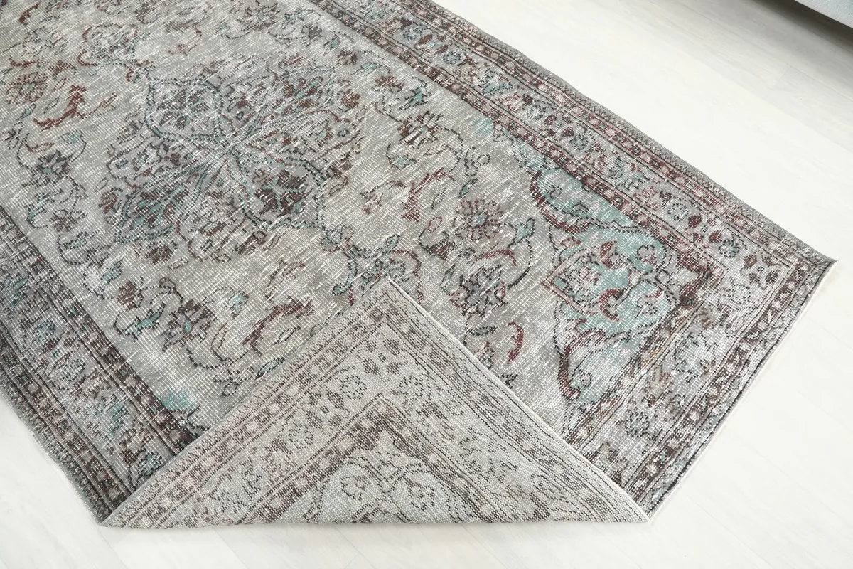 Folded corner of the rug, revealing the reverse side and knotting detail
