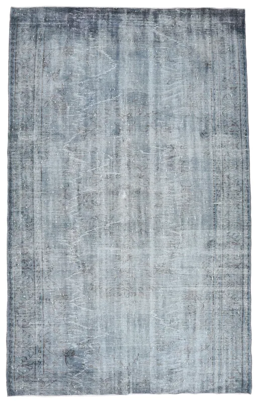 Full overhead view of the charcoal and gray distressed vintage Anatolian rug on a white background