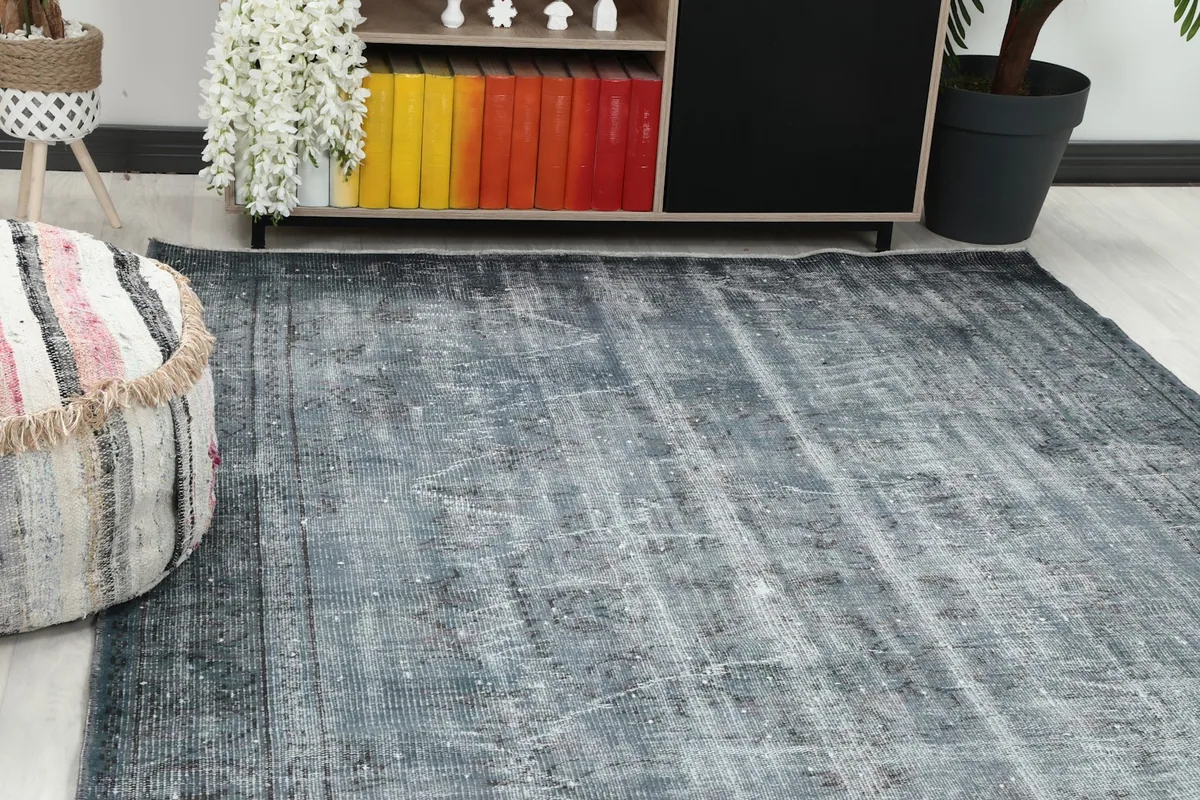 Close-up angle showing the distressed texture and subtle gray tones of the rug