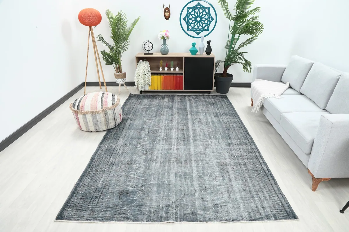 Charcoal and gray vintage rug displayed in a living room setting with modern furniture