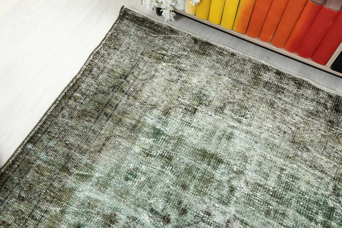 Overhead angled view of the rug, capturing its full length and the interplay of light on its surface.