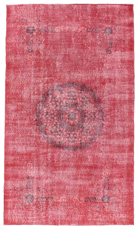 Full top view of a 5'4" x 9'2" red vintage Anatolian area rug with a central charcoal medallion.