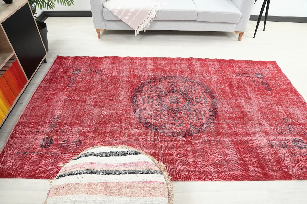 Red vintage rug in a room setting, showing its size and color in context.