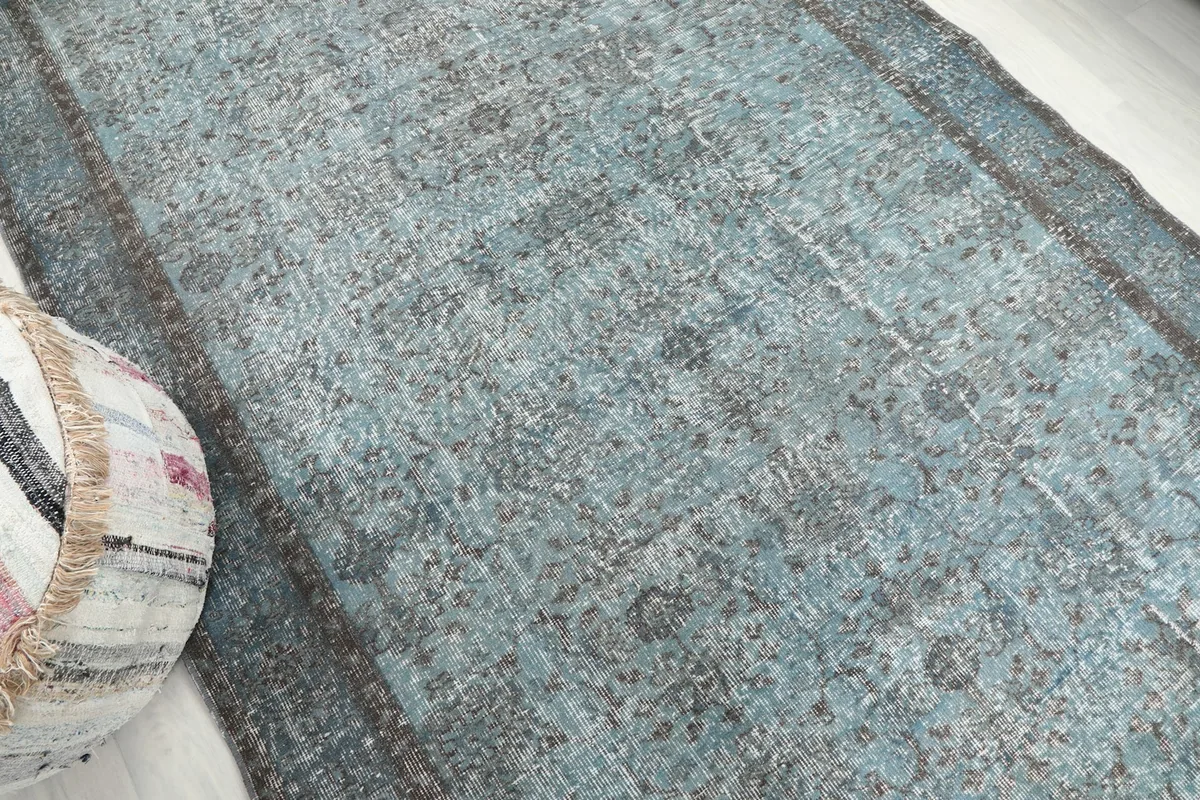 Diagonal view across the blue rug, showing its texture and pattern variation