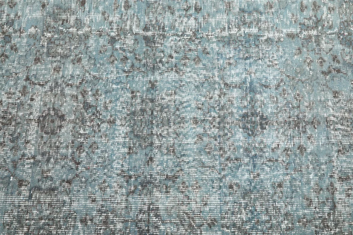Close-up of the low pile and distressed surface of the blue and brown rug