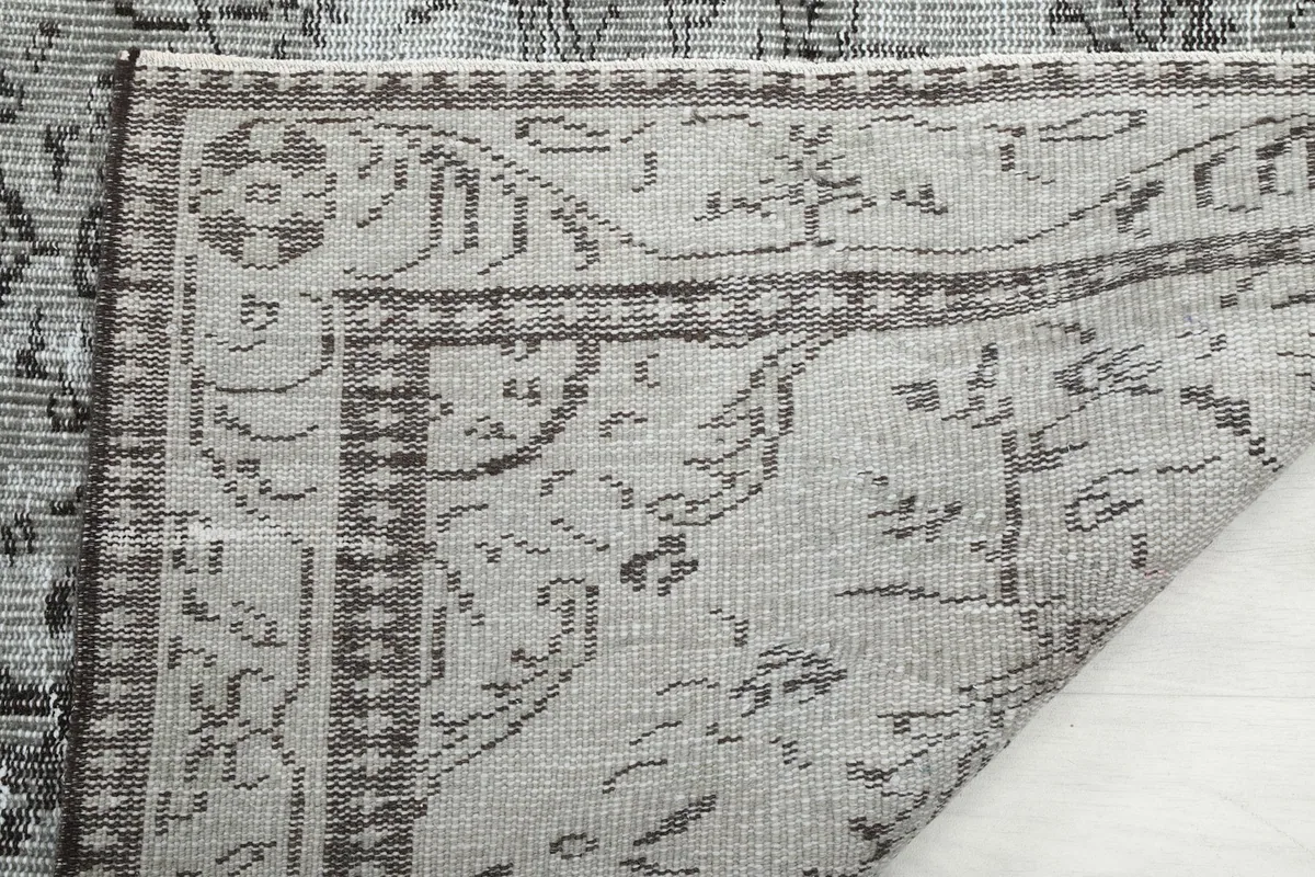 Underside of the rug, revealing the cotton foundation and hand-knotted structure
